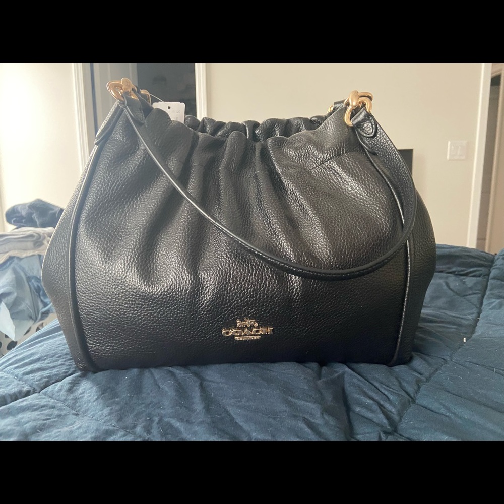 Brand new coach bag. Too big for me. Perfect condition. Never used.